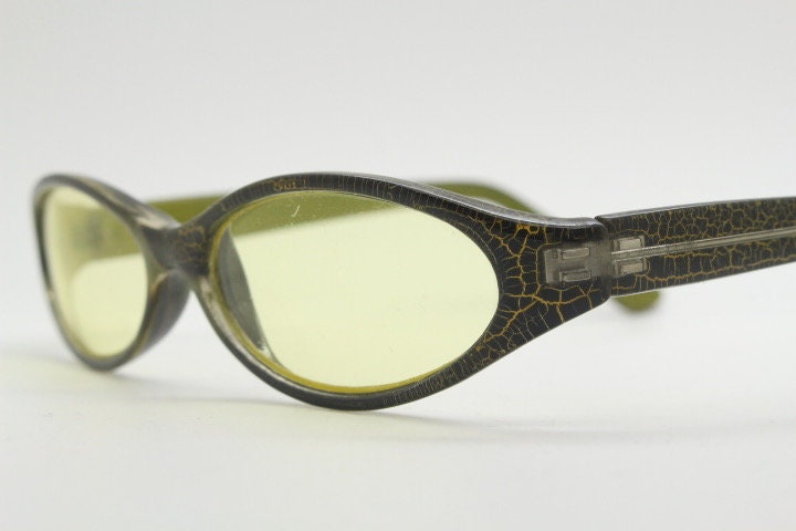 90s vintage abstract oval sunglasses. Thick curve around black frame with psychedelic yellow crackle print. Mini mask. Cosplay NOS