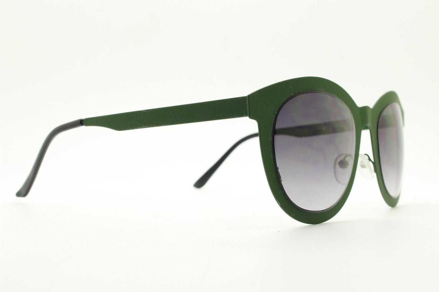 Round vintage cat eye sunglasses. Green flat metal frame in a slightly rubber finish that encases the lenses. Womens 2000s modified cateye