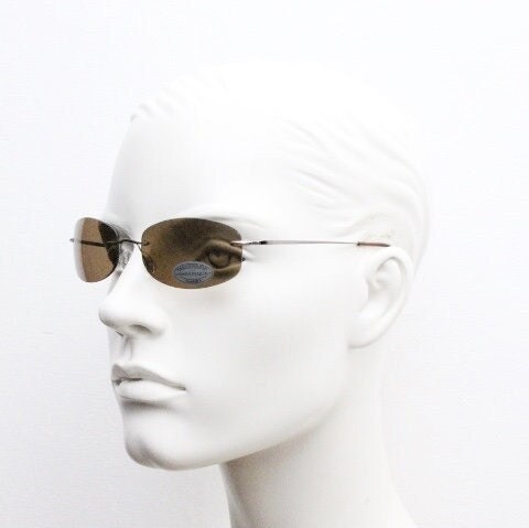 Faconnable 90s vintage sunglasses model 859 hand made in Italy. Minimal frameless design with flexible wire arms and brown chrome trim. NOS
