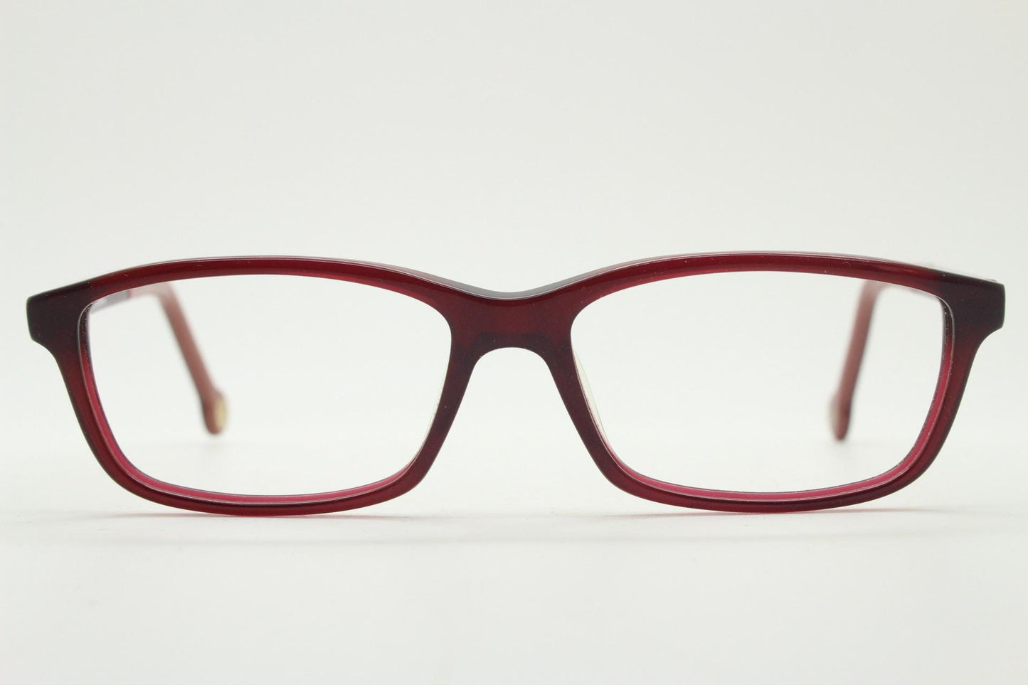 Carolina Herrera rectangular low profile eye glasses. Dark pink acetate optical frames with tasteful arm logo. Prescription RX eyeglasses