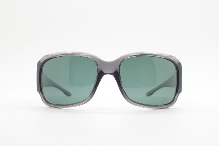 Polaroid Y2K vintage shield sunglasses. Transparent grey wrap around with red diamante LOVE logo and polarising lens. 2000s. Rhinestone