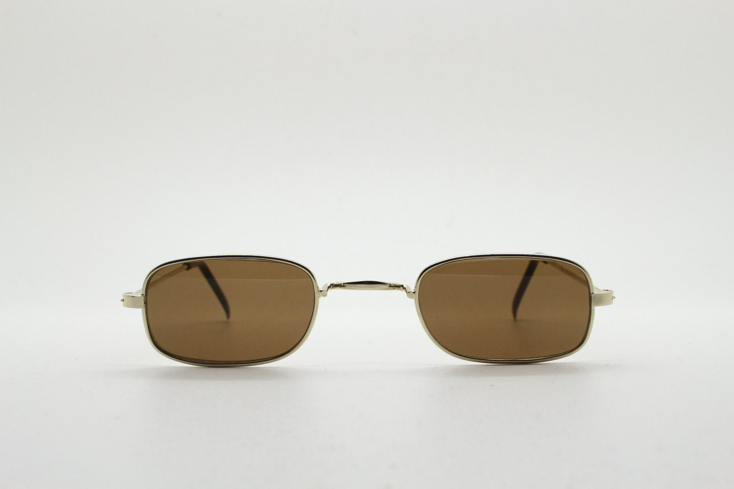 80s vintage rectangular low profile metal sunglasses. Minimal 60s mens mod design in gold chrome frame with brown lenses. NOS
