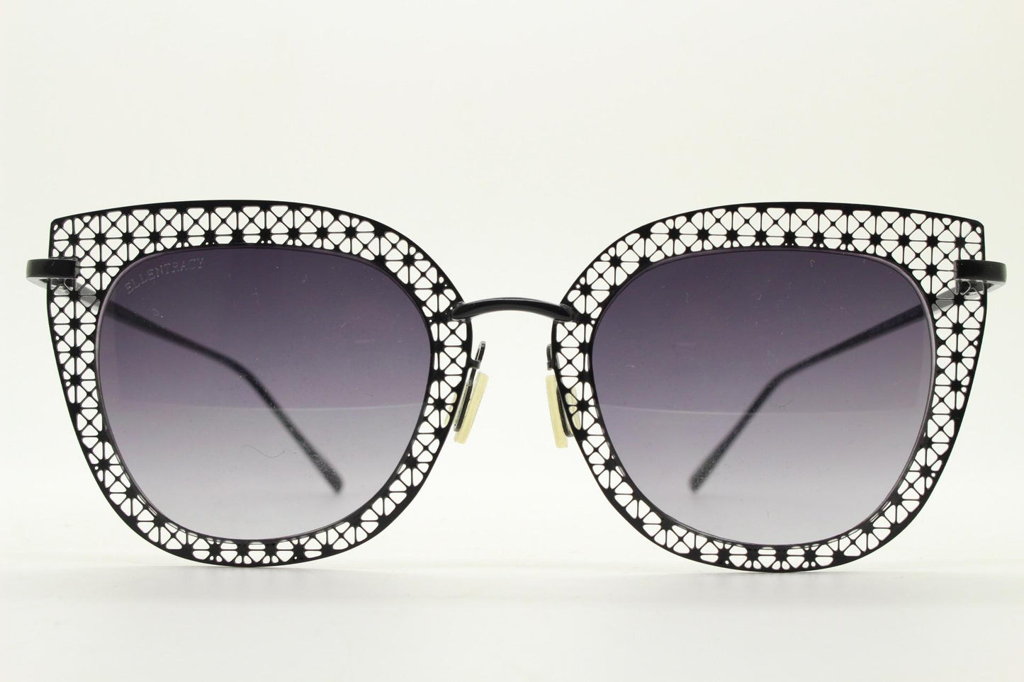 Metal cut out vintage cat eye sunglasses.  Women's imaginative black lacey pattern flat cateye frame with smoky graduating lenses