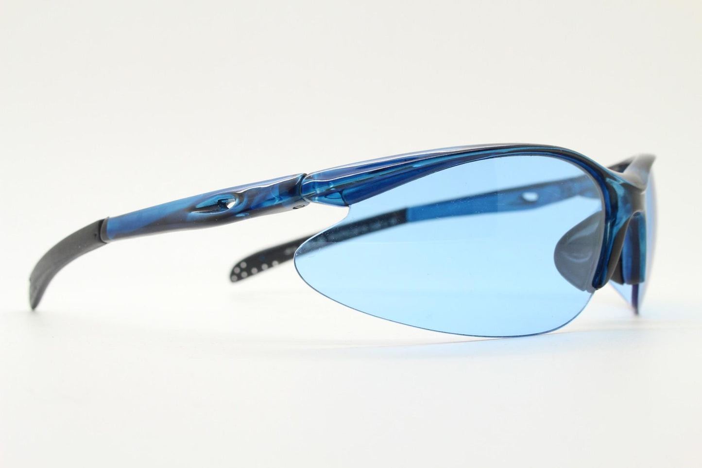 Y2K vintage sport shield sunglasses. Transparent blue frame wraparound aerodynamic visor with matching lenses. 2000's. 90s