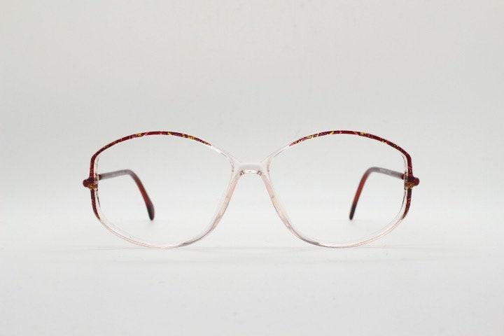 Silhouette 80s vintage hexagon eye glasses made in Austria. Transparent crystal optical frame with abstract red pattern. Prescription RX