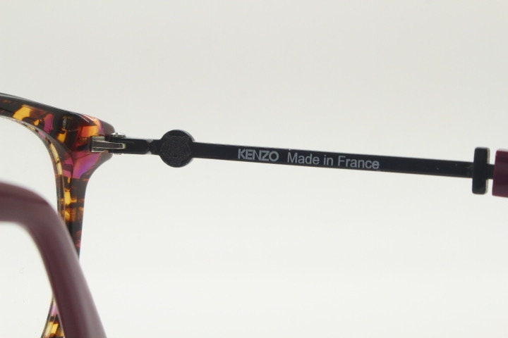 Kenzo vintage round eye glasses made in France. Tortoise with purple tones and matching arm sections. Womens Prescription Optical frames. RX