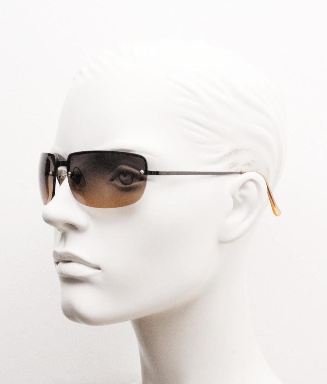 Y2K vintage curved rectangular sunglasses. Minimal half frame in brown chrome with grey to amber fade lenses. 2000's. 00's NOS