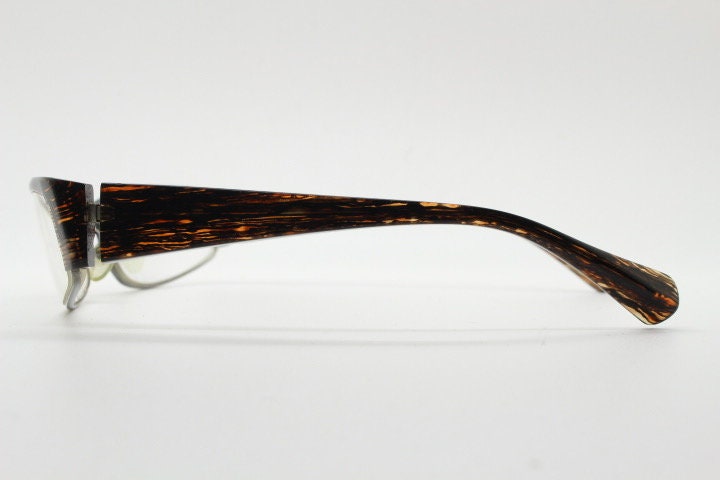 Alain Mikli 90s vintage eye glasses hand made in France. Low profile wrap around half frame in 'wood grain' acetate. Optical prescription RX