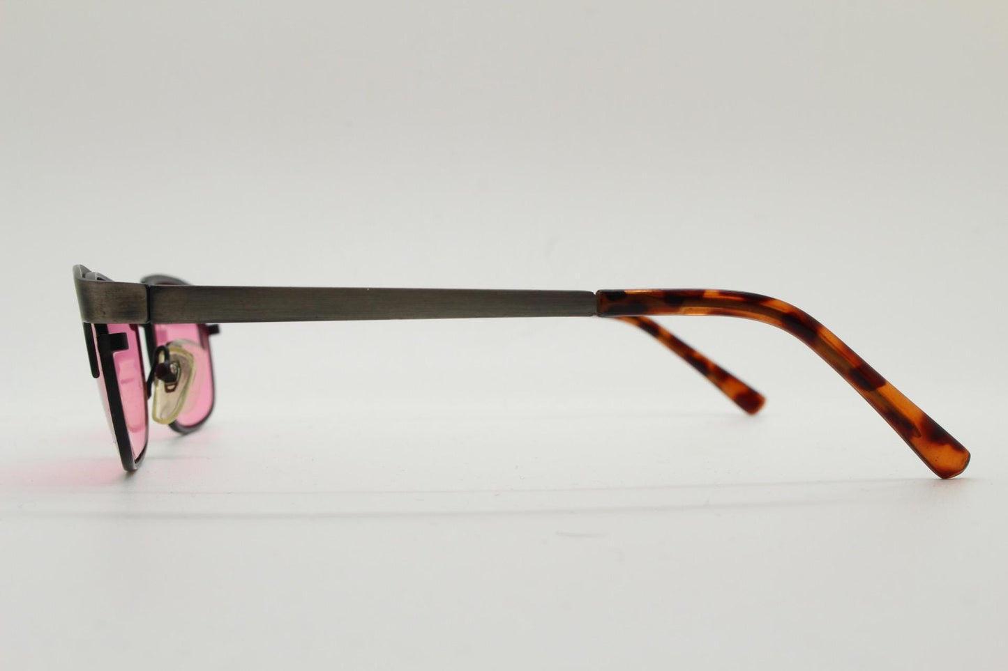 90s vintage rectangular sunglasses with bright pink lenses. Solid metal low profile frame in a brushed bronze finish. Y2K. NOS