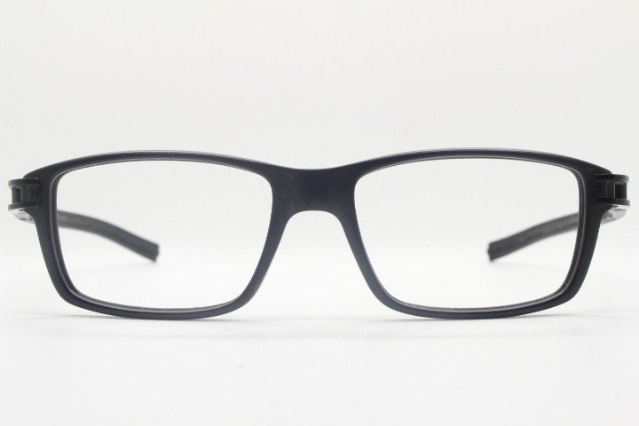Tag Heuer rectangular eye glasses. Patented design made in France. Solid acetate optical frame with flexible rubber arms. Prescription RX