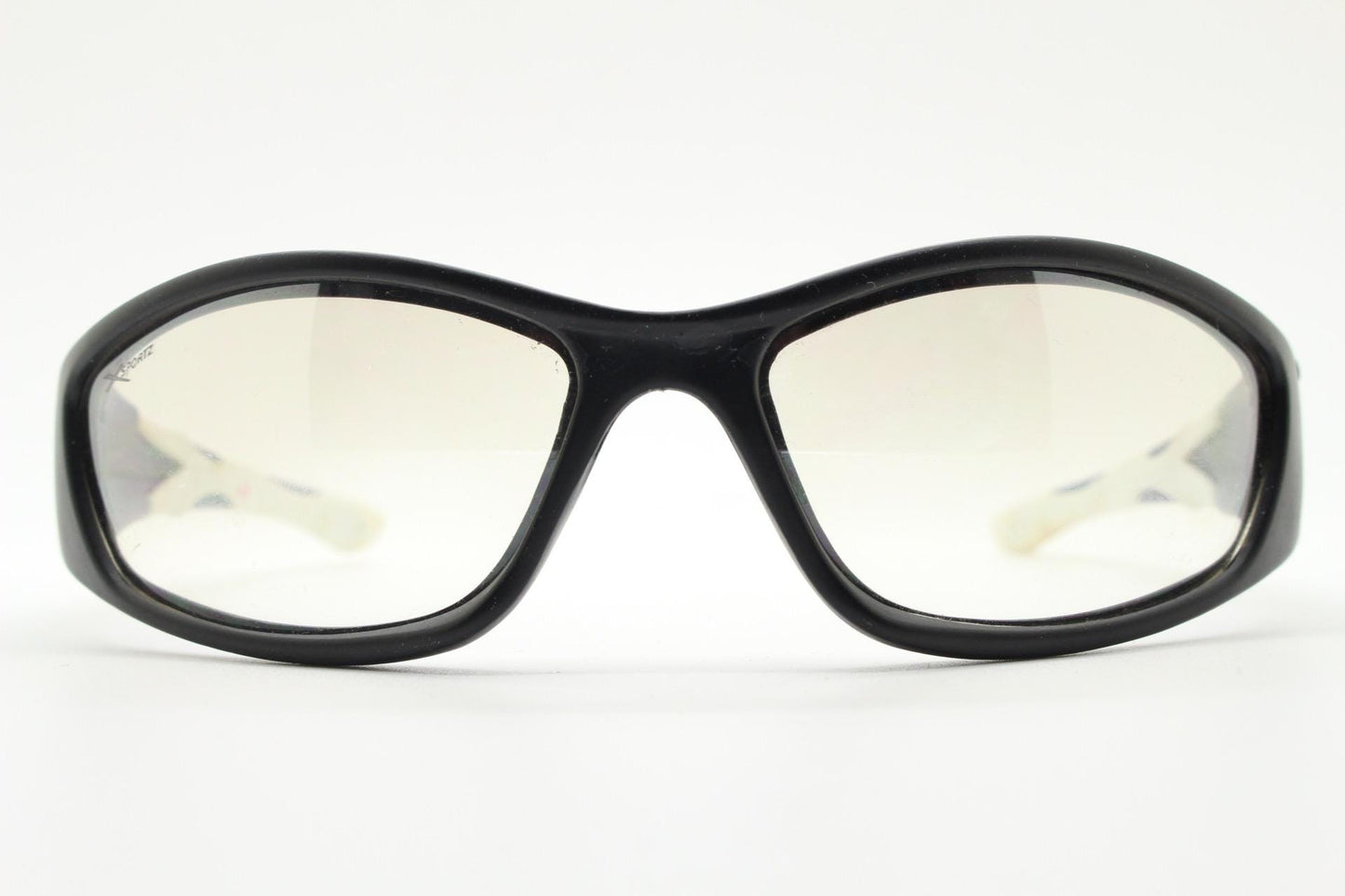 90s vintage sports sunglasses. Black matt aerodynamic wraparound with straight white rubber arms and light tone lenses. Y2K rave shield