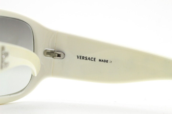 Versace Y2k vintage wrap around bug eye sunglasses. Curving white acetate shield frame with huge spell out diamante logo. 2000s. Rhinestone