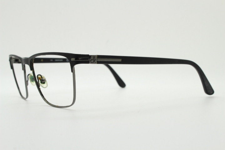 Calvin Klein rectangular eye glasses. Gunmetal grey chrome wire optical frames with black matt brow. Prescription eyeglasses. RX Spectacles