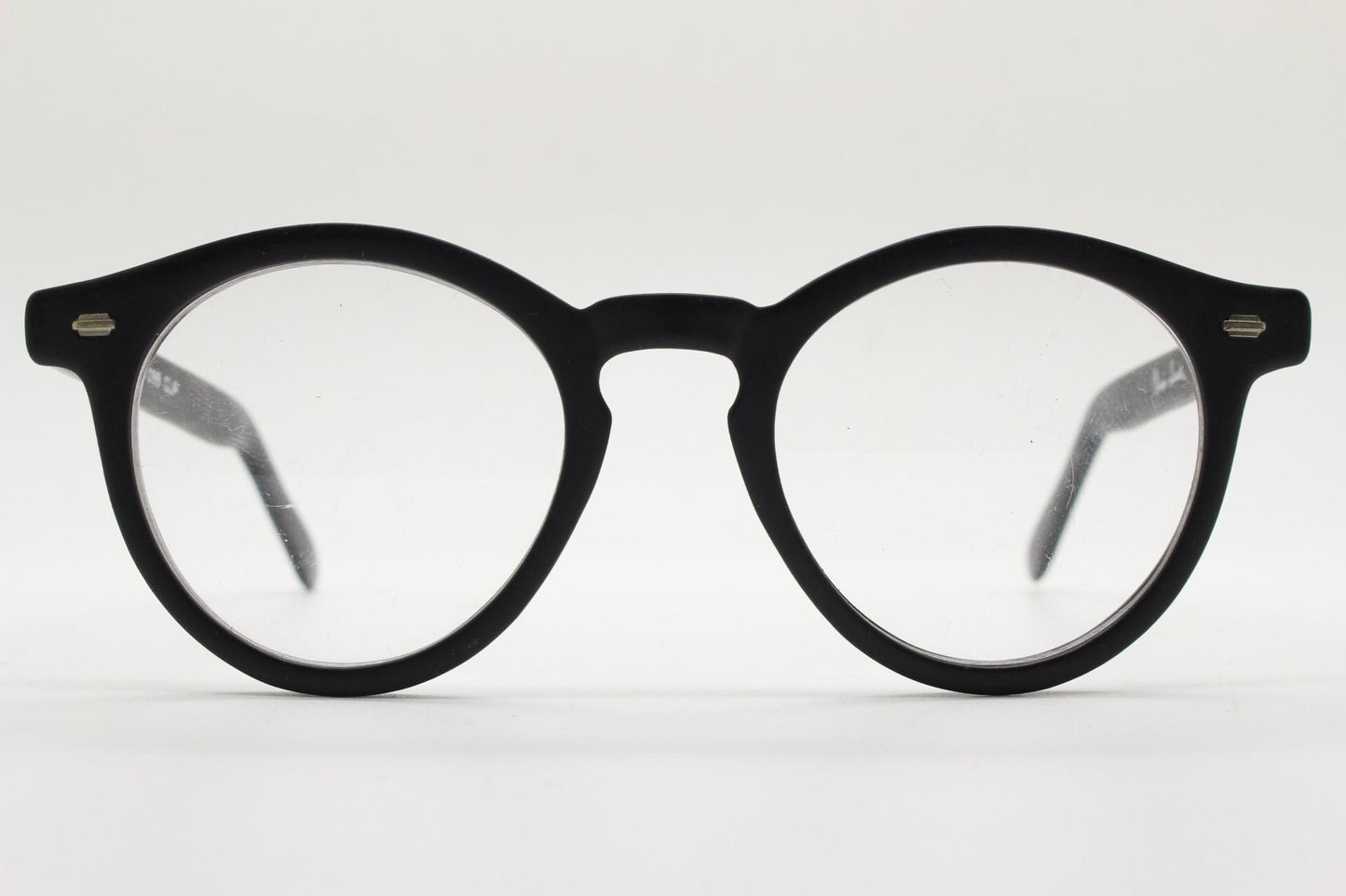 Oliver Smith round eye glasses. Black matt finish optical frames with protruding corners and keyhole bridge. Prescription RX eyeglasses