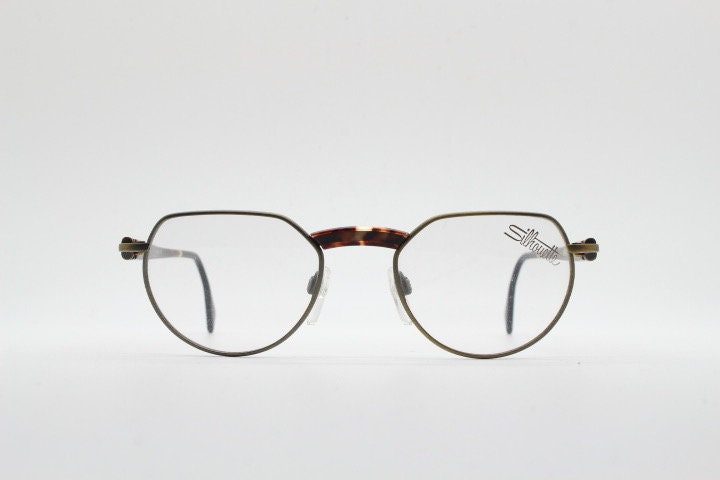 Silhouette vintage 90s flat top oval eye glasses made in Austria. Satin bronze optical frame with honey tortoise trim. Prescription RX