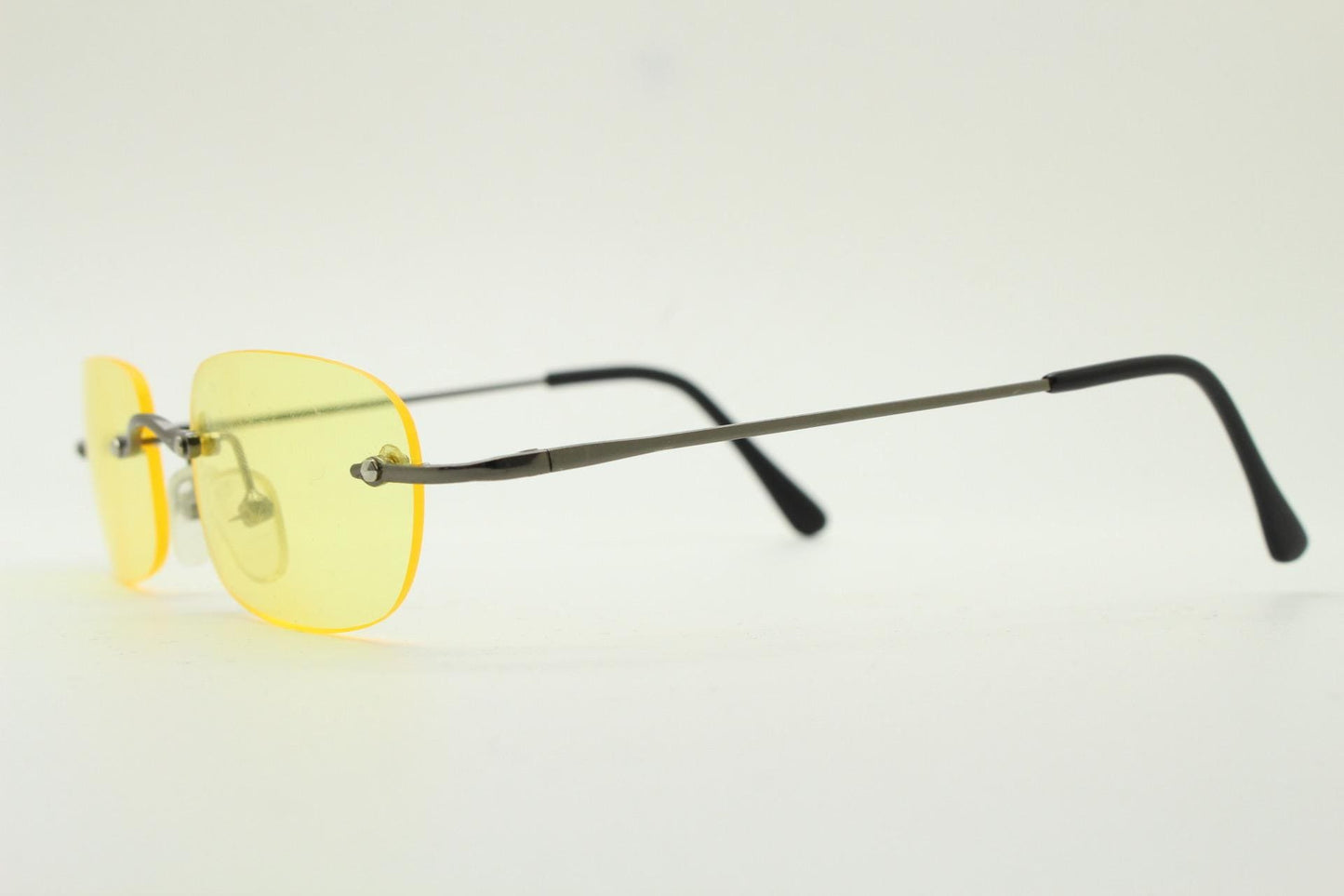 Y2K vintage frameless yellow sunglasses. Rectangular lenses with grey metal bridge and arms. 2000s club kids. 00's. 90s Rave