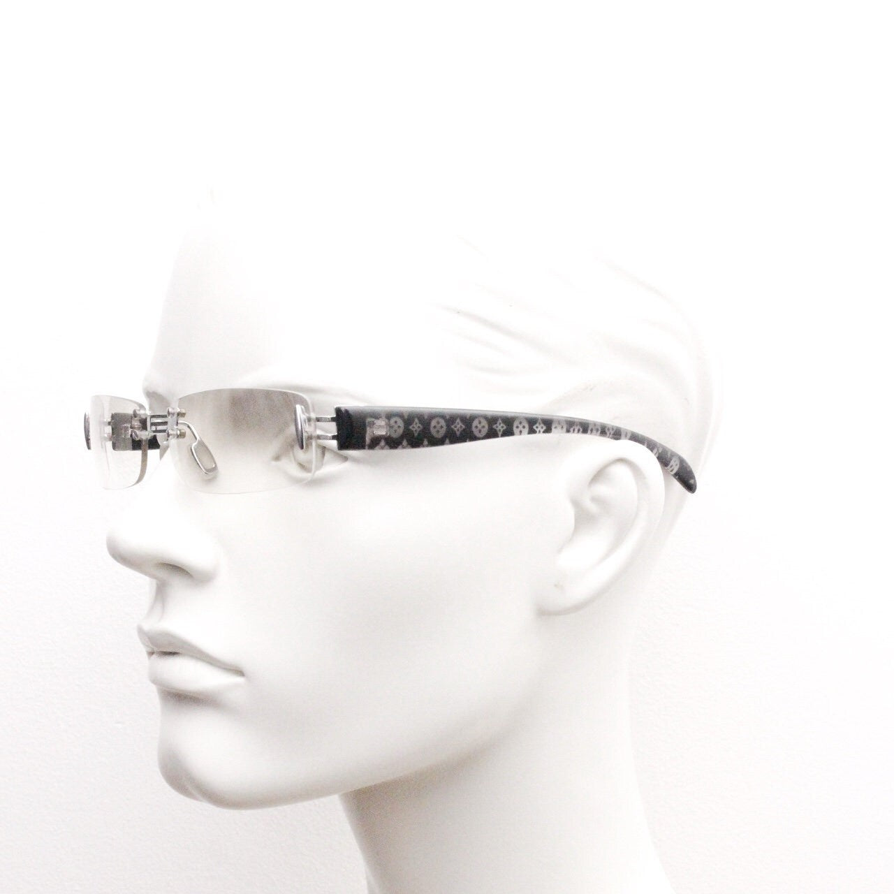 Y2K vintage frameless sunglasses. Silver chrome trim with patterned arms and extra light tone graduated curved mirror lenses. 2000's. 90s