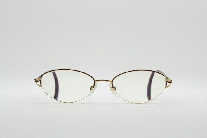 Silhouette oval half frame eye glasses model 6566 made in Austria. Minimal optical frame with gold trim deep purple arms. Prescription RX