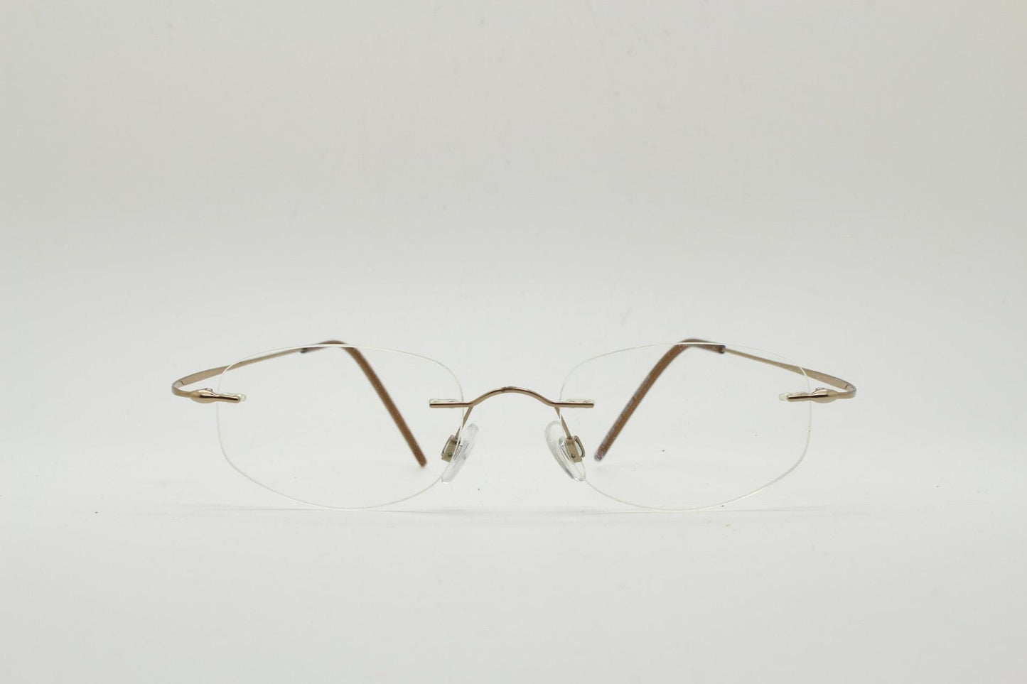90s vintage angular oval frameless eye glasses. Minimal lightweight titanium optical frame. Flexible prescription RX spectacles