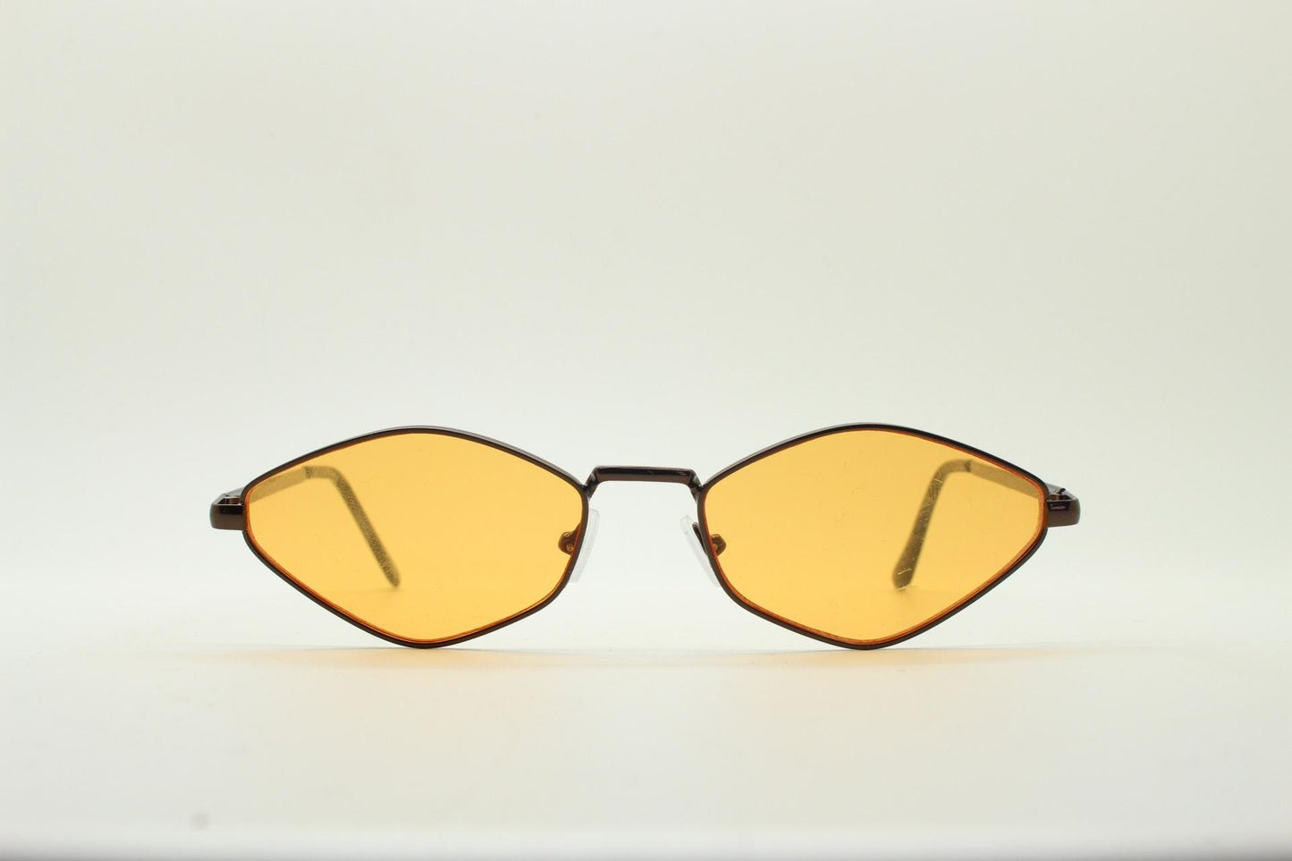 90s vintage pointed hexagon sunglasses. Minimal bronze brown psychedelic mod style frame with blazing orange lenses. Unused NOS