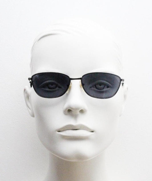 90s vintage angular pointed sunglasses. Minimal grey chrome metal frame with embossed patterned arms. Subtle cat eye. NOS