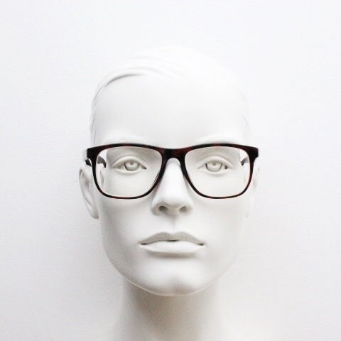 Versace modified wayfarer design eye glasses made in Italy. Mottled brown acetate optical frames with subtle logo. Prescription eyeglasses