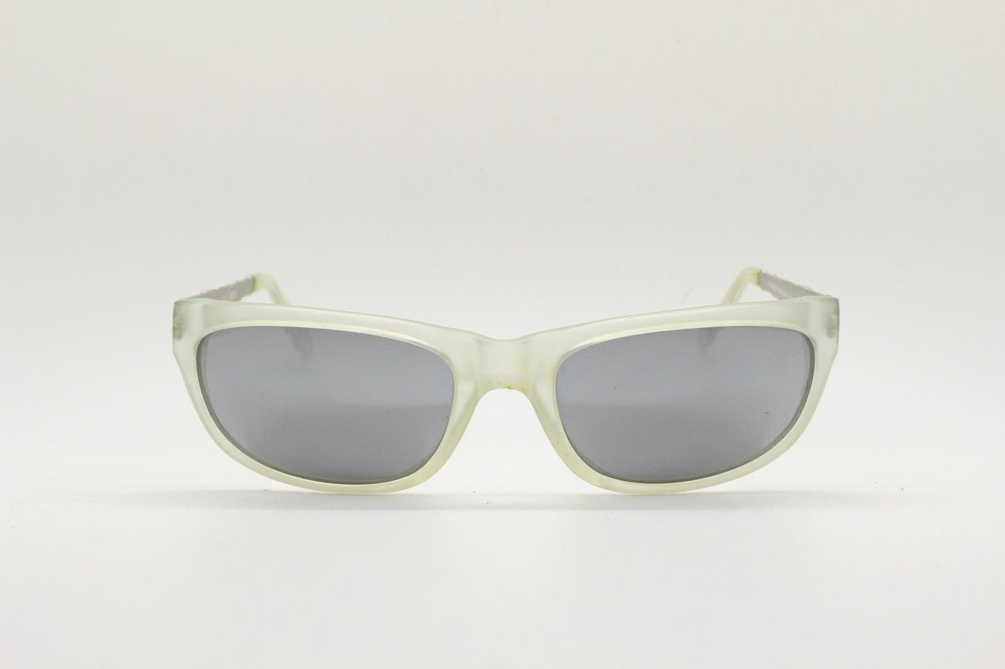 Dakota Smith vintage 90s futuristic sunglasses. Transparent frosted wrap around shield frame with mirror lenses and ornate arm patterns