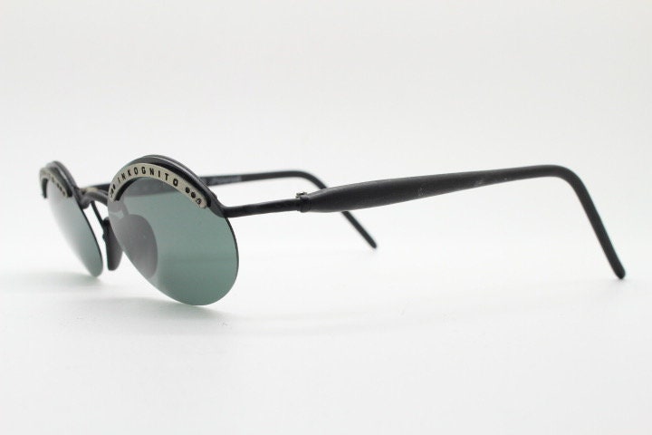 Inkognito 90s vintage small oval sunglasses. Matt finish half frame with spell out logo brow and polarising lenses. NOS