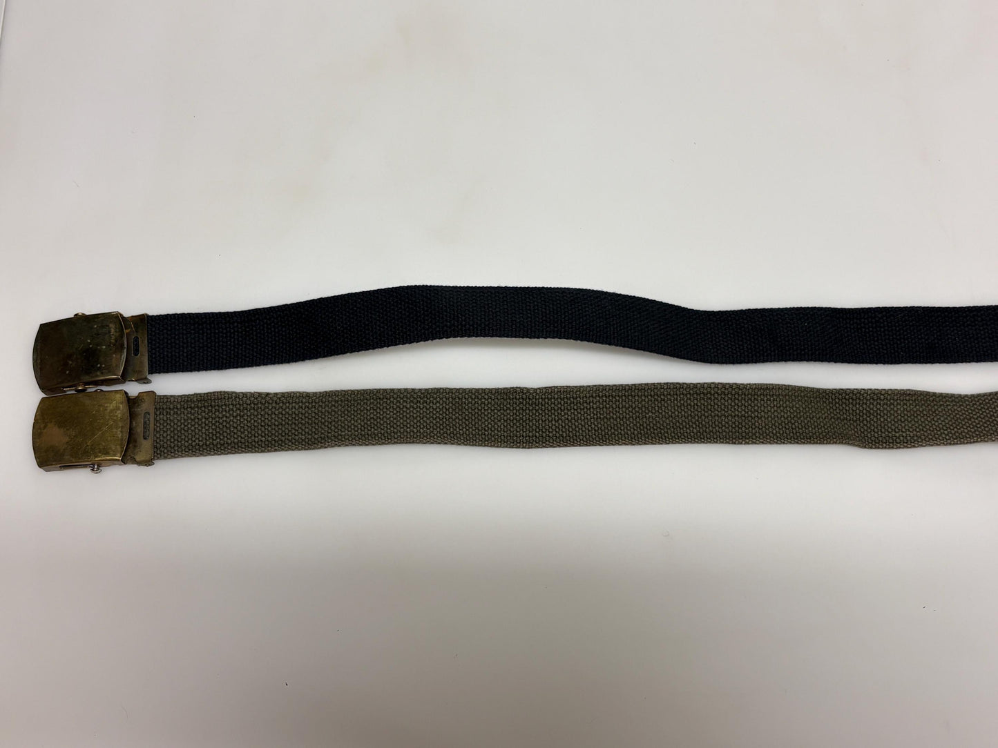 2 x bundle 80s vintage canvas army belts. One black plus one khaki green no holes format. Slide lock gold buckle. Webbing. Fully adjustable