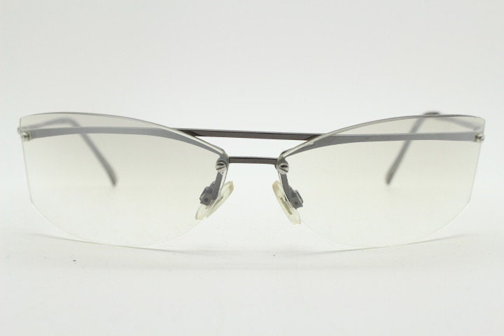 Y2K vintage wraparound sunglasses. Sick fashion grail half frame in grey chrome with extra light tone curving mirrored lenses. 2000's NOS