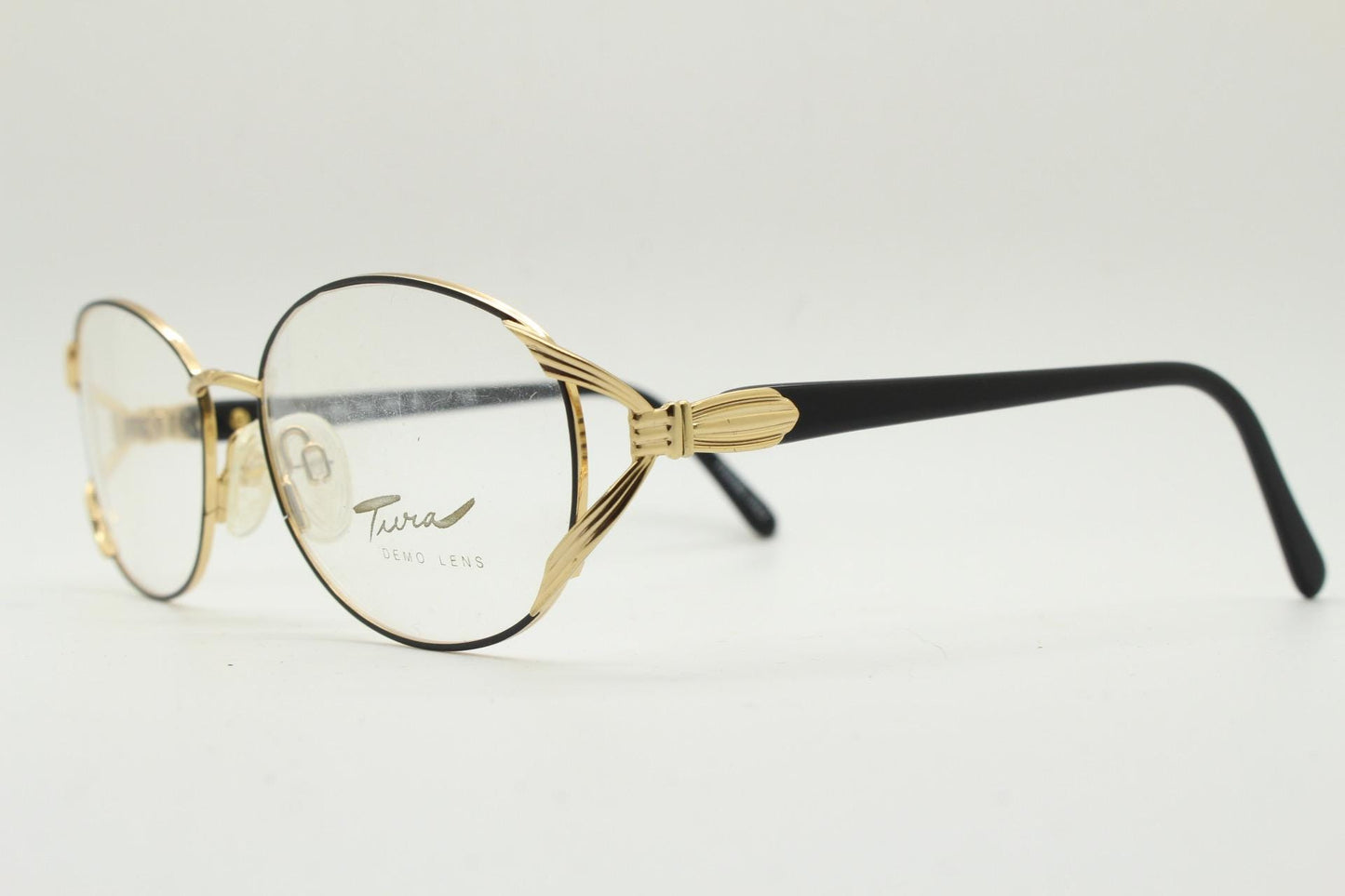 Tura 80s vintage oval eye glasses made in Italy. Womens black and gold optical frame with Y forked temples. Prescription RX. Unused NOS