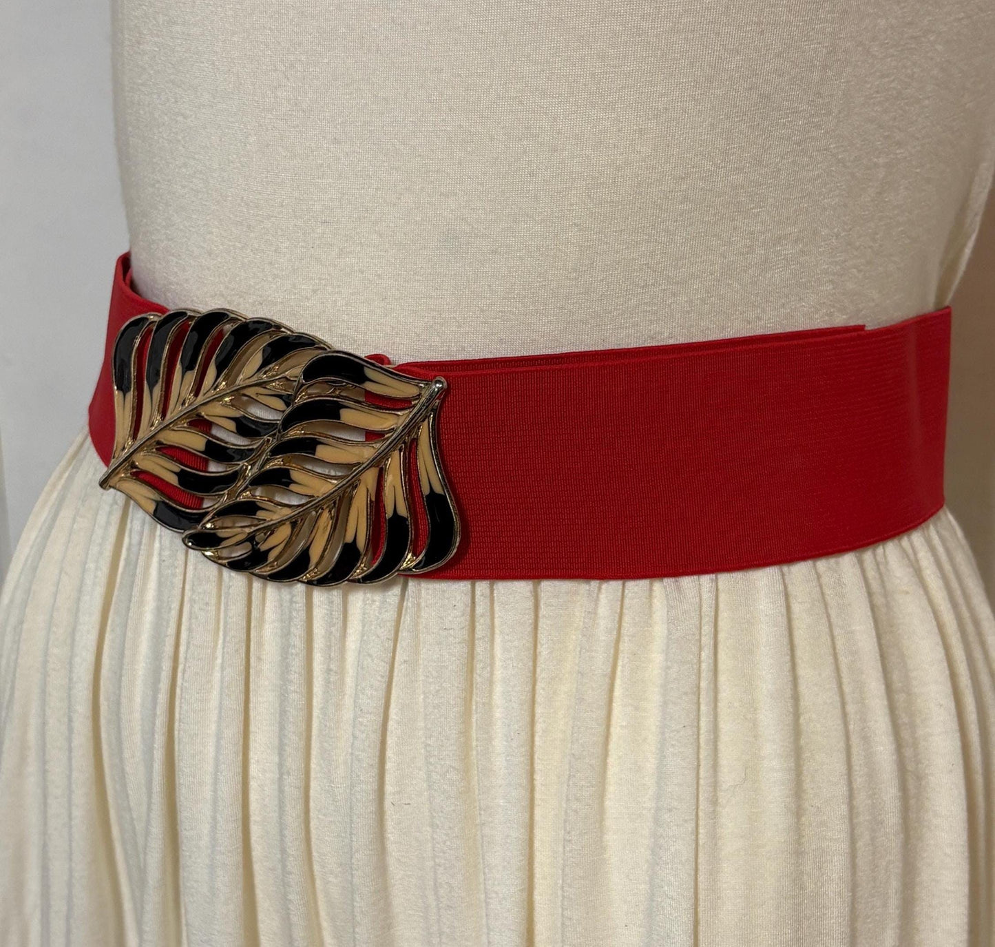80s vintage womens elastic tall belt. Large exotic palm leaf buckle. Flattering cinch effect. Extensive adjustable size range. Unused NOS