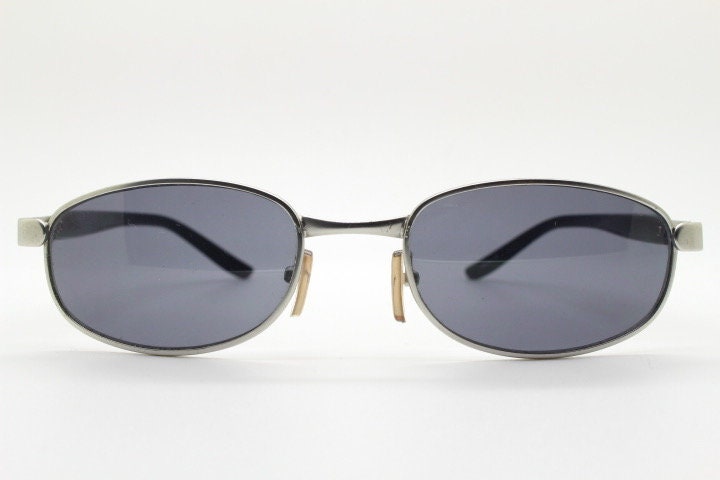 90s vintage small bug eye rectangular sunglasses. Satin finish silver frame with black gloss arms. Unused. 2000s. NOS