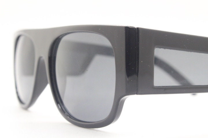 Y2K vintage rectangular side panel sunglasses. Black gloss frame with grey lenses and side window spoilers / blinkers. 2000s NOS goggle