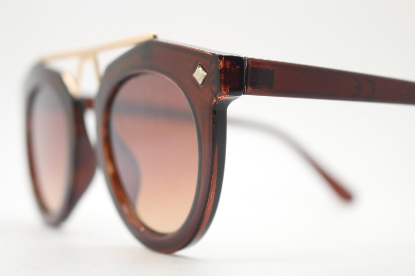 Rounded cateye sunglasses with gold 'scaffold' metal bridge. Women's transparent frame with matching brown graduating lenses. Vintage NOS