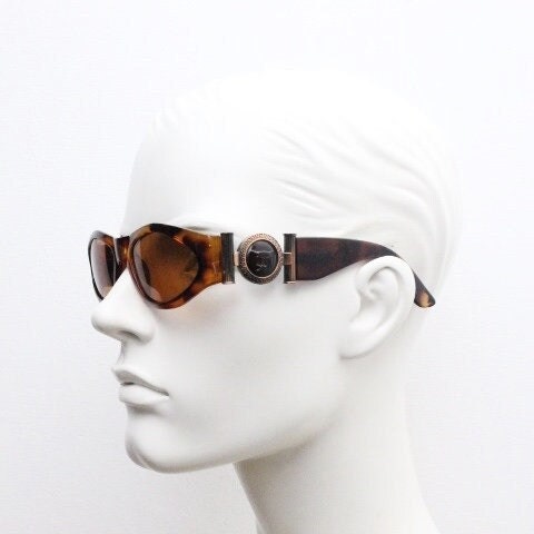 90s vintage oval sunglasses. Low profile transparent tortoise frame with massive bronze metal arm crests BNWT. Unused NOS