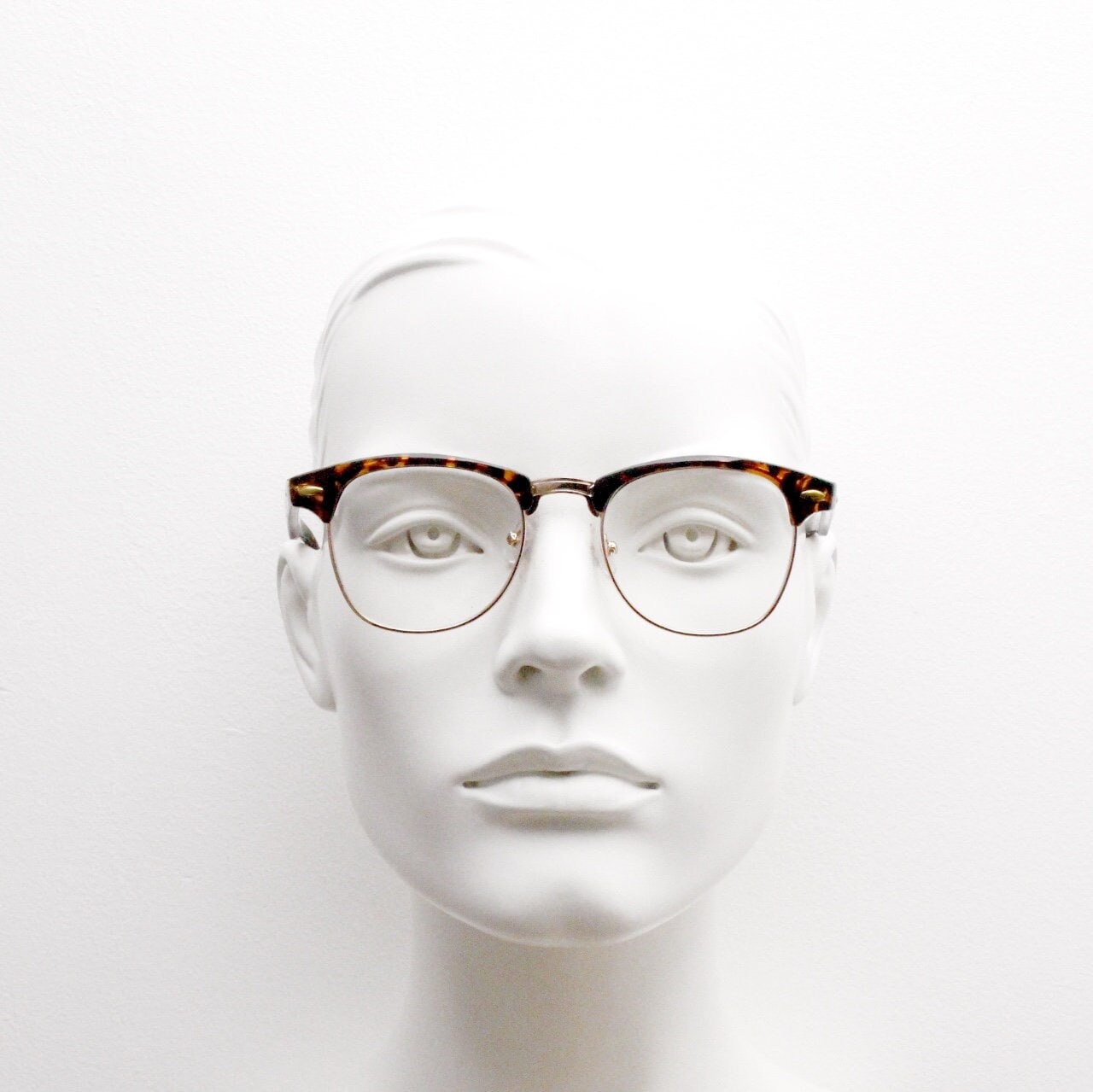 90s vintage half frame glasses. Tortoise browline eyeglasses in a gloss finish with gold underwire and clear lenses . Mens 50s, 60s design