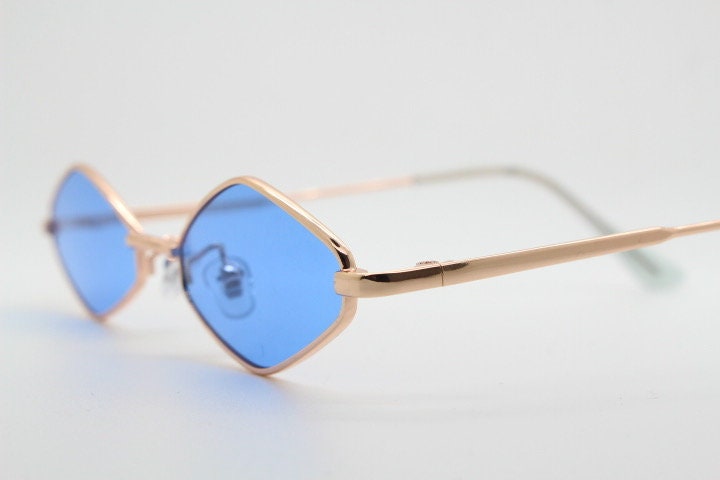 90s vintage small diamond sunglasses. Minimal gold psychedelic mod style frame with sky blue lenses. Unused New Old Stock