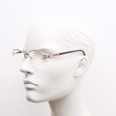 Silhouette oval half frame eye glasses model 6566 made in Austria. Minimal optical frame with gold trim deep purple arms. Prescription RX