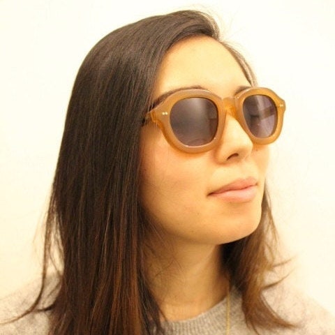 Kopajos thick framed round sunglasses. Hand made transparent amber acetate chunky frame with contrasting graduating lenses