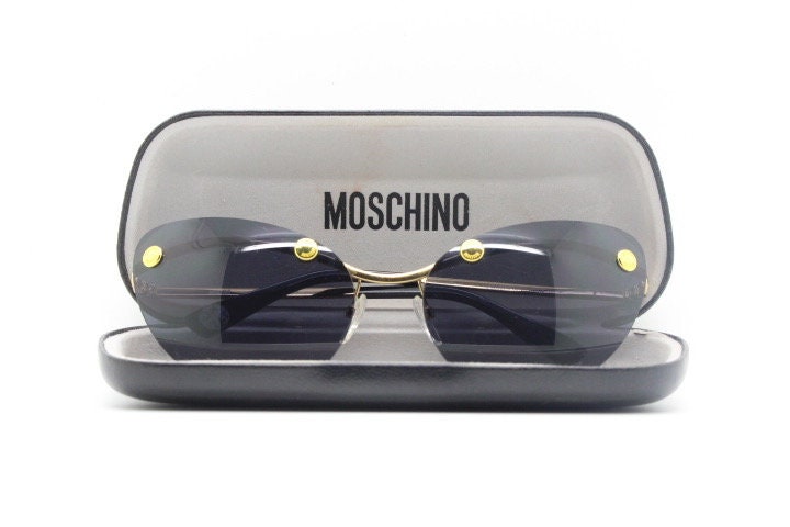Moschino oval cat eye sunglasses model 082/S. Womens frameless cateye in perfect proportions with golden metal brow line