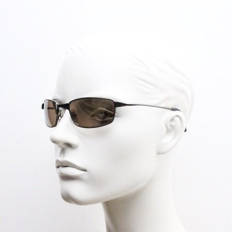 90s vintage curved rectangular sunglasses. Solid metal low profile frame in brown chrome with slightly mirrored lenses. 2000's. Y2K NOS