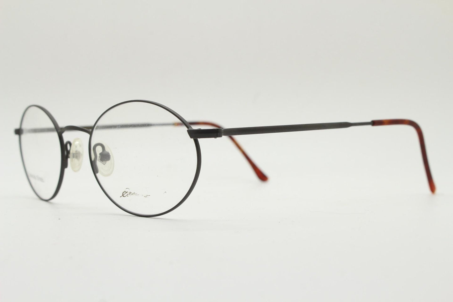 Eddie Bauer 90s vintage oval eye glasses. Minimal black matt finish optical frames with kinked arms. Stainless steel spectacles. NOS
