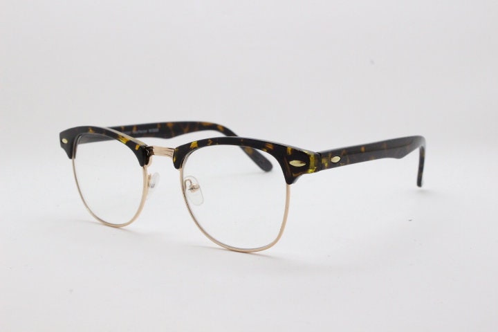 90s vintage half frame glasses. Tortoise browline eyeglasses in a gloss finish with gold underwire and clear lenses . Mens 50s, 60s design