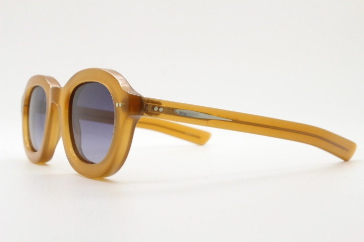 Kopajos thick framed round sunglasses. Hand made transparent amber acetate chunky frame with contrasting graduating lenses