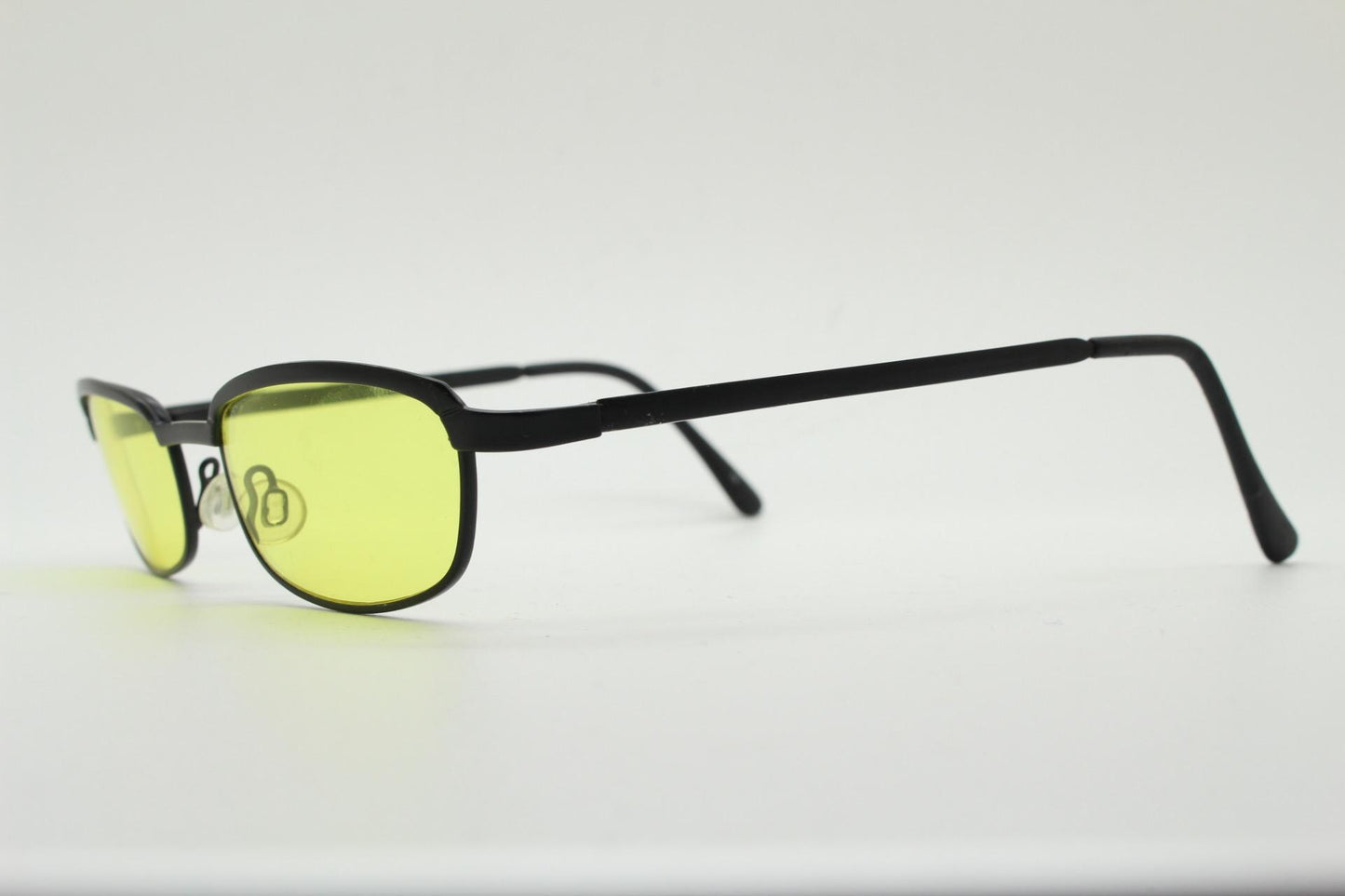 Vintage small rectangular sunglasses. Authentic quirky 90s design in a matt black solid metal frame with bright yellow lenses. 2000s. NOS