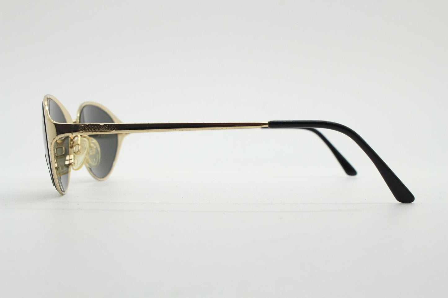 Blue Bay 90s vintage oval cat eye sunglasses made in Italy by Safilo. Dynamic gold chrome finish with contrasting dark lenses. NOS with tag