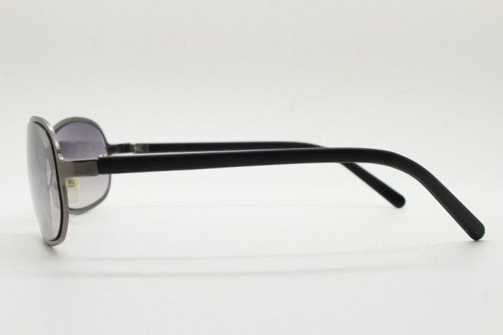Y2K vintage mini bug eye sunglasses. Curved gunmetal grey flat metal frame with black matt arms and graduating lenses. Unused 2000s NOS