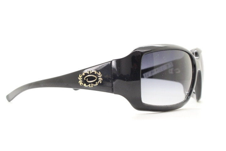 Oscar De La Renta Y2K vintage shield sunglasses. All black gloss wrap around visor with graduating lenses. 2000's bug eye mini mask