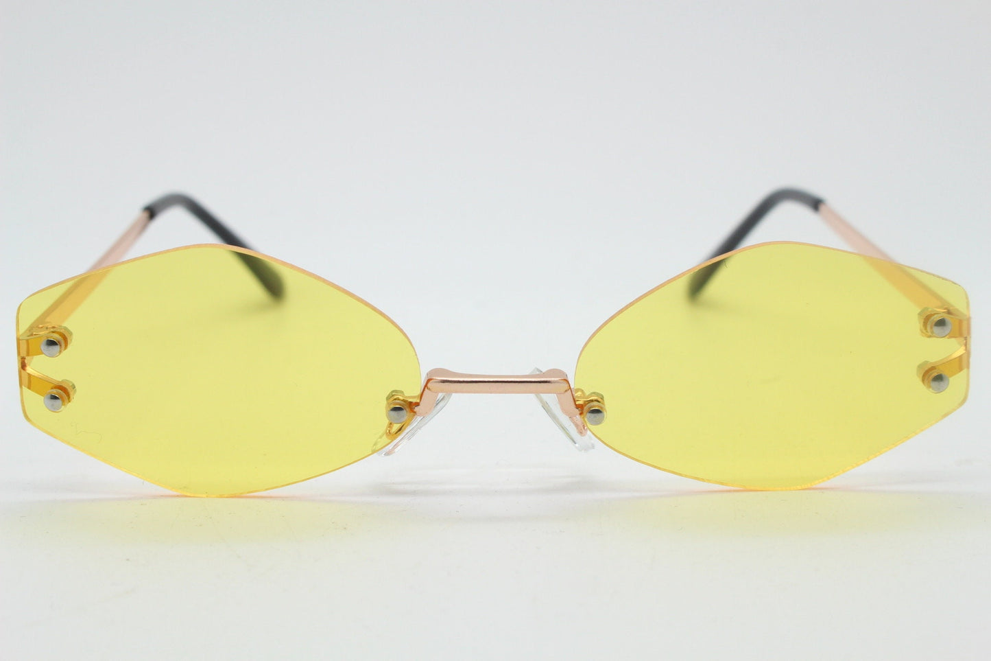 Y2K vintage frameless hexagon sunglasses. Bright yellow lenses with rose gold bridge and arms. 2000s, 00's. 90s